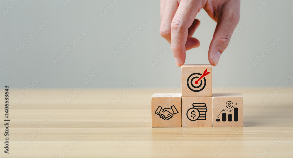 Aufkleber hand placing wooden block with target icon on top of pyramid structure representing business strateg