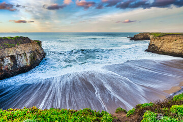 Coastal cliffs along California's Highway 1 in California. Rugged ocean rocks, crashing waves, and...