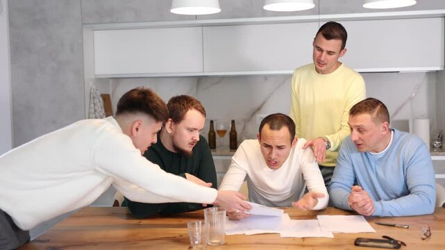 Troubled man reading legal notice surrounded by friends providing moral support sitting at table n home kitchen during informal friendly meeting