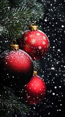 Christmas ornaments hang from an evergreen branch amidst softly falling snow, creating a festive ambiance