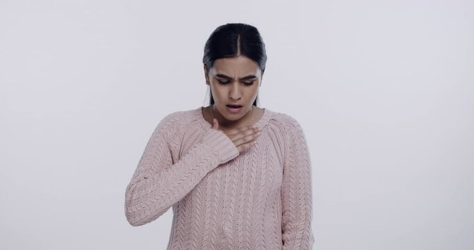 Woman, cough and chest pain in studio with sick, asthma and bronchitis or allergy by white background. Young person, portrait and breathe or ill lungs, pneumonia and breathing problem or tuberculosis