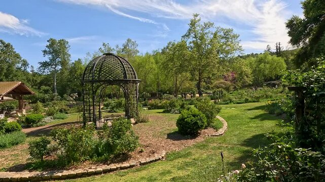 footage of a gorgeous spring landscape with a gazebo, colorful flowers and lush green trees and plants at Descanso Gardens La Canada Flintridge California USA