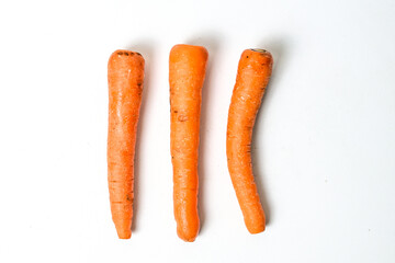 Top view of three (3) fresh carrot isolated on white background. Clipping path. High angle. above.
