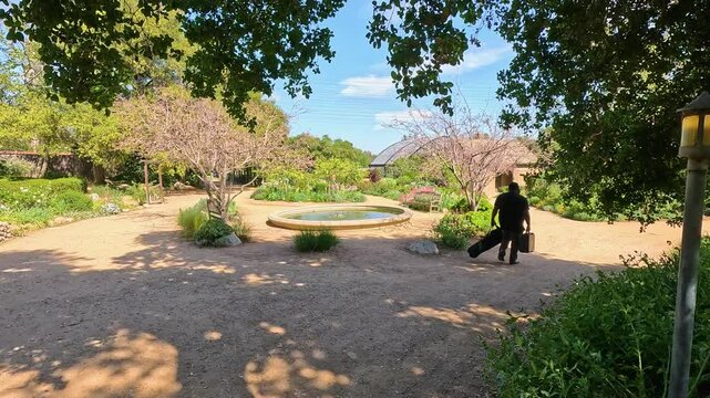 footage of a water fountain with lush green trees and plants and colorful flowers at Descanso Gardens La Canada Flintridge California USA