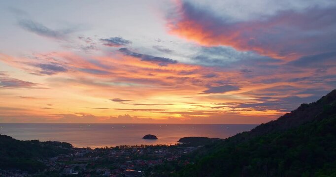 aerial view scenery sweet sky in sunset above the island. 
the sun going down to the sea beside Pu island at Kata Karon beach Phuket Thailand
stock mage in travel concept. sweet sky background.