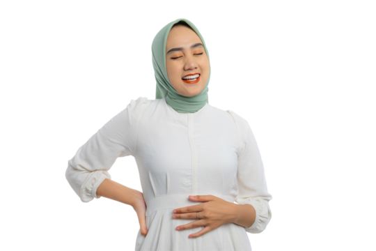 Satisfied young Asian woman in green hijab and white blouse touching her stomach feeling full after delicious meal with relieved expression isolated on transparent background