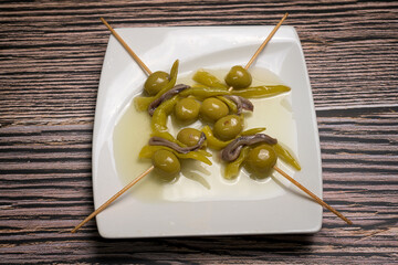 Traditional Spanish Gilda Pintxo Skewer with Olive, Anchovy and Pickled Pepper