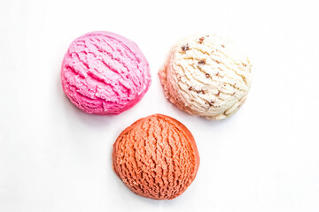 several flavors of ice cream scoops isolated on white background