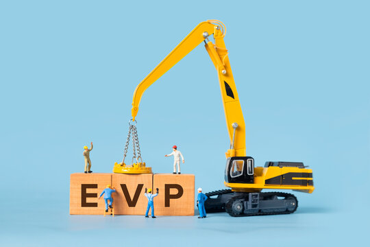 The word EVP is written on a wooden box, miniature people and excavator trucks make up the box.