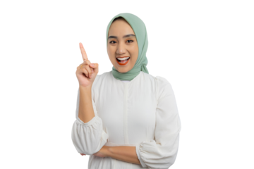 Happy young Asian woman in green hijab and white blouse having creative idea, pointing finger up at copy space isolated on transparent background