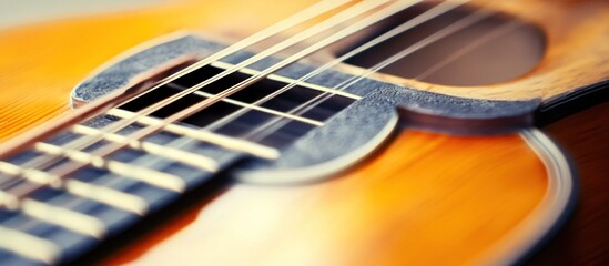 Obraz premium Close-up shot of an acoustic guitar showcasing its strings and fretboard details with focus on musical craftsmanship