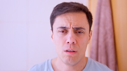 Obraz premium Sick man feeling physical discomfort at home