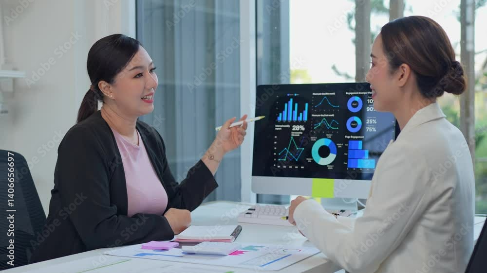 Poster financial analysts discussing market trends while reviewing investment data charts on computer scree