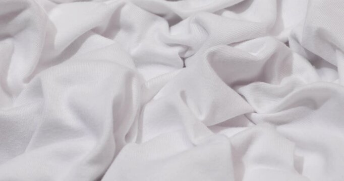 White fabric background. White cloth waves background texture. White fabric cloth textile material.