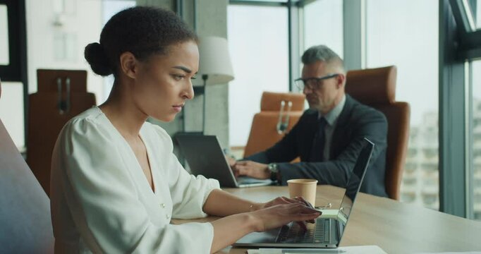 Focused businesswoman working on laptop in office