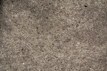 Gray Concrete Wall Texture. Rough Textured Surface. Warm Gray Old Concrete Backgroud. Close up. Wall with Visible Irregular Cracks.Weathered Stone Texture.