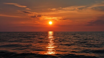 Fototapeta premium Ocean Sunset: Fiery Hues and Golden Reflections