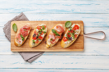 Tasty antipasto toasts featuring classic caprese with mozzarella and tomatoes, and savory...