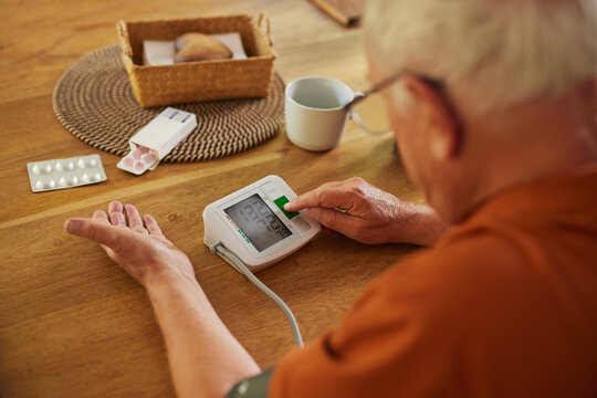 Senior man measuring blood pressure