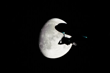 Silhouette of an Airplane in front of Moon