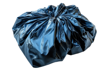 Large dark blue plastic bag filled with items in a cluttered workspace environment