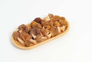 Fresh Morel Mushrooms (Morchella esculenta) in Oval Bamboo Dish on White Background