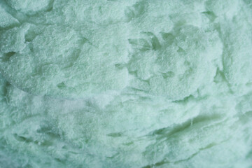 Obraz premium Green background with texture of synthetic filler. Close-up of the texture. 