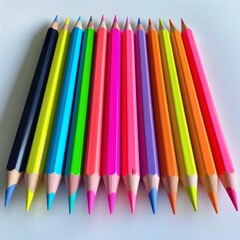 Fototapeta premium Vibrant Array: Close-Up of Sharp Colored Pencils in a Row on White Background - Creative and Educational Resource