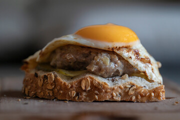 cutlet sandwich with scrambled eggs from one egg, close-up of an egg yolk, sandwich for lunch, 