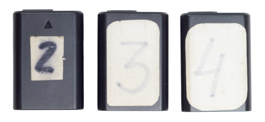 Isolated set of rechargeable batteries with numbers for digital camera on white background