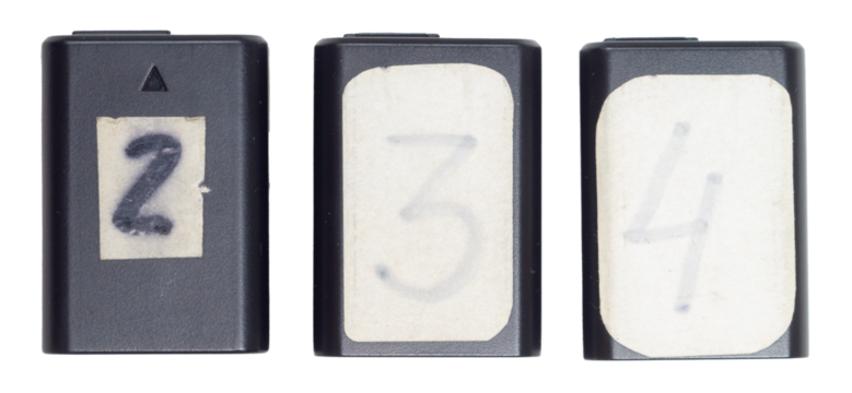 Isolated set of rechargeable batteries with numbers for digital camera on white background