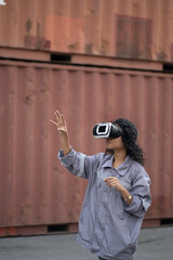 Obraz premium Asia worker woman use VR headset working with checking container at container site 