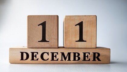 Minimalist photo of wooden blocks with date 11 December. Day and month, calendar on white background
