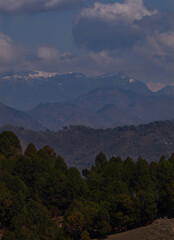 Himalayan spring landscape mountains with snow and clouds.