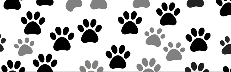 Fototapeta premium A_pattern_of_black_and_gray_paw_prints_scattered_across_a_white_background---cute-and-playful---like_a_dog_or_cat_themed_design
