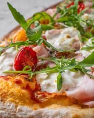 Italian pizza with mozzarely and dilapidated muzzle with a pistachio on a wooden board. Close angle of all pizza ingredients