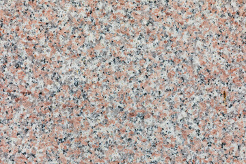 A close-up shot of a granite surface, capturing its realistic texture.
