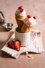 Erdbeereis in zwei Eiswaffeln in einem Becher. Sommer, Dessert, Steintisch.