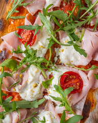 Italian pizza with mozzarely and dilapidated muzzle with a pistachio on a wooden board. Close angle of all pizza ingredients