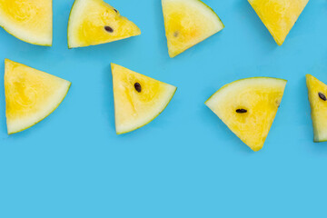 Yellow watermelon slices on blue background.