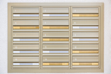 Multiple wall mounted mailboxes outside an apartment building in London