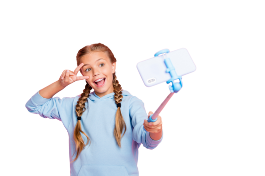 Photo of casual cheerful excited cute blonde girl wearing blue sweater taking selfie using self stick at leisure isolated over pink pastel color background