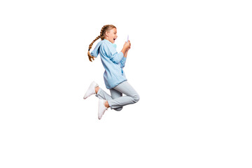 Full length body size photo of excited crazy ecstatic schoolchild browsing through phone jumping wearing blue sweatshirt sweater sportive wear jeans denim isolated over pink pastel color background