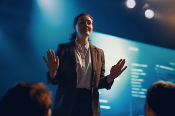 A woman is speaking on stage