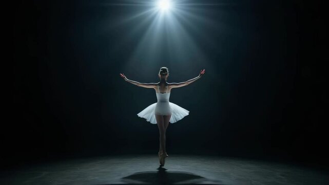 Graceful ballet dancer in spotlight performing elegant pose on stage, showcasing art and beauty in dance with soft lighting in dark background
