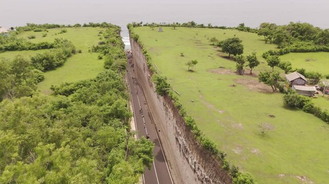 Aerial Flight Over Tanah Barak Cliff in Bali, Indonesia. Drone Footage Showcasing Dramatic Coastal Landscape and Rugged Rock Formations.