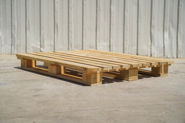 Wooden Pallet on a Warehouse Floor with Metal Wall Background