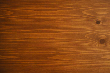 A smooth, varnished wood tabletop with visible grain patterns and warm lighting—styled for product or food photography