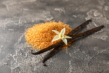 Aromatic vanilla sugar. Vanilla pods. Vanilla sticks, brown and white sugar in a bowl on a textured...
