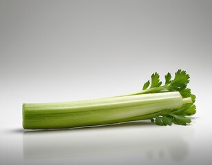 Fototapeta premium Fresh green celery stalk on a smooth, neutral background, showcasing its vibrant color and crisp texture.